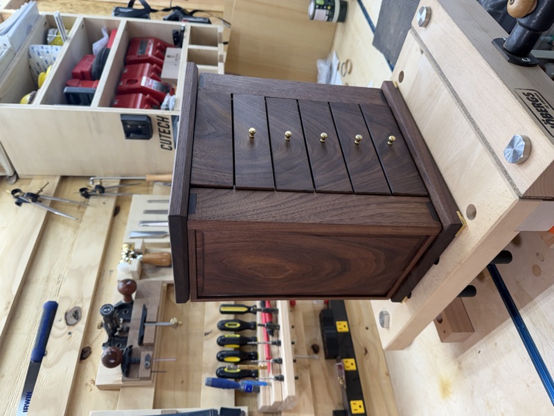 Walnut Jewelry Cabinet: Closed, on the bench